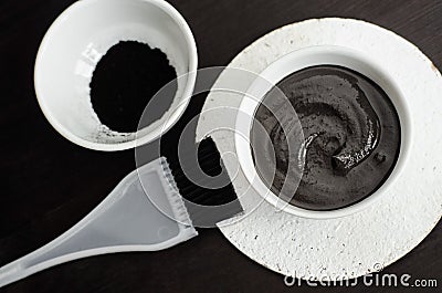 DIY charcoal face mask in a small ceramic bowl. Homemade cosmetics. Stock Photo