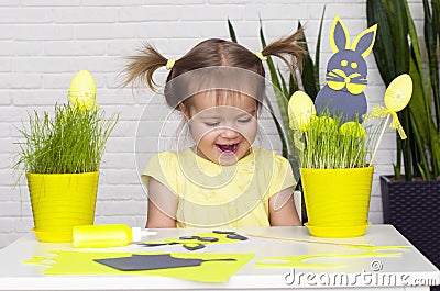 Happy little girl makes felt bunny for Easter dÃ©cor. Easter Stock Photo