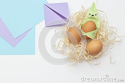 DIY Children's Easter craft bunny with an egg. Easter paper step by step instructions. Happy bunny holds egg. Stock Photo