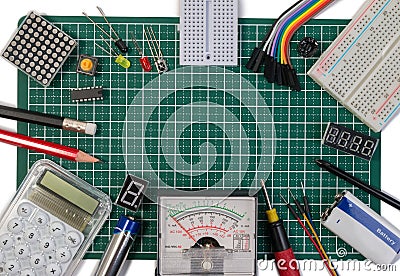 DIY electrical maker tools components on green cutting mat board. Stock Photo