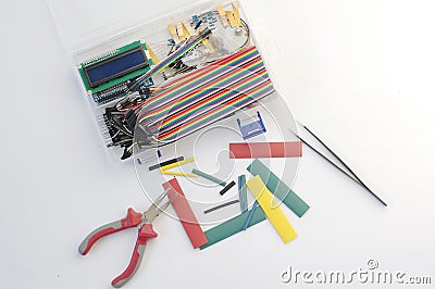 DIY electronics hobby kit opened heatshrink laying around on the grey background. DIY engineer electronic kit set. Stock Photo