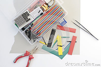 DIY electronics hobby kit opened heatshrink laying around on the grey background. DIY engineer electronic kit set. Stock Photo