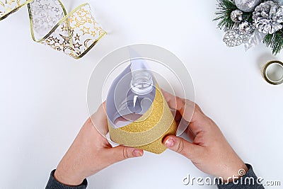 DIY gold bell from a plastic bottle. Guide on the photo how to make a decorative bell from a bottle, paper and a Christmas ball Stock Photo