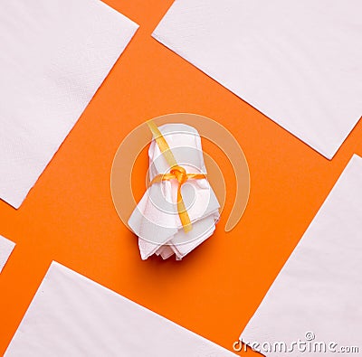 DIY Halloween candy ghost step by step. Image three. Wrap the candy and tie it with ribbon. Stock Photo