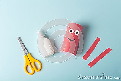 DIY and kids creativity. Step by step instruction: how to make octopus from toilet roll tube. Step2 glue roll with paper and cut Stock Photo