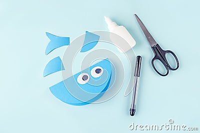 DIY and kids creativity. Step by step instruction: how to make shark from paper. Step5 glue eyes. Children Craft workshop Stock Photo