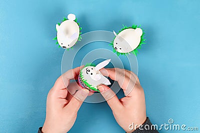 Diy rabbit from easter eggs on blue background. Gift ideas, decor Easter, spring. Handmade Stock Photo