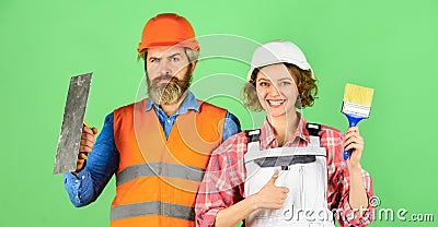 DIY repair. Construction workers. Home renovation. Cheerful couple renovating house. Woman builder hard hat. Man Stock Photo