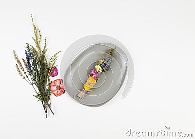 DIY smudge stick to banish bad energy. Dried herbs and flowers are tied into a bundle with a thread. Homemade incense Stock Photo