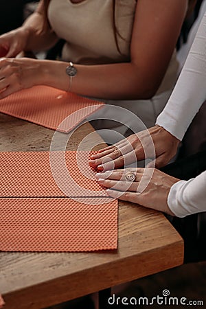 DIY wax candle making process. Woman making decorative wax candle, close-up of hands. Stock Photo