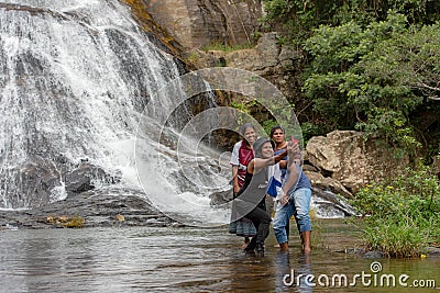 Local People take a selfie Sunny day in the Tropical waterfall falls from the Editorial Stock Photo