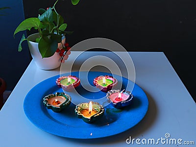 Lit Diyas placed in plate for celebrating diwali and dhanteras Stock Photo