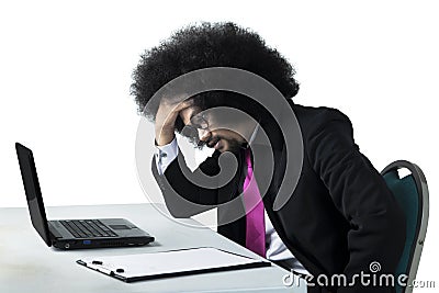 Dizzy Afro businessman working with laptop Stock Photo