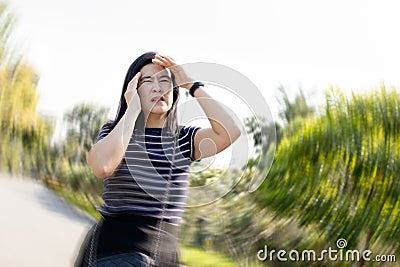 Dizzy woman suffering from vertigo,sensation of whirling,spinning around,loss of balance,she walked with stagger,vertigo while Stock Photo