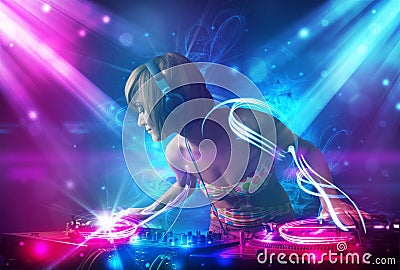 Dj girl mixing music with powerful light effects Stock Photo