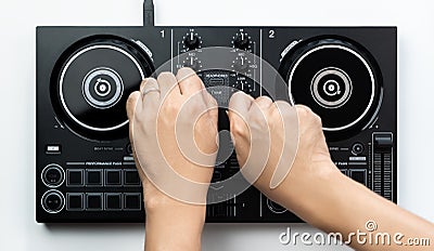DJ hands mixing music on DJ Digital mixing controller top view on white background Stock Photo