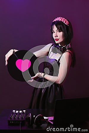 Dj headphone equipment disco girl party retro vintage ultraviolet mixer young woman vinyl glamor valentine`s day plastic pink Stock Photo