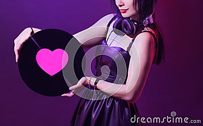 Dj headphone equipment disco girl party retro vintage ultraviolet mixer young woman vinyl glamor valentine`s day plastic pink Stock Photo