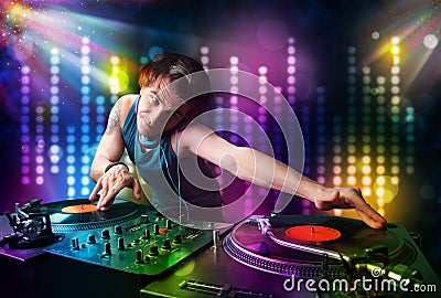 Dj playing songs in a disco with light show Stock Photo