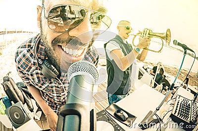 Dj playing summer hits at sunset beach party on spring break event Stock Photo