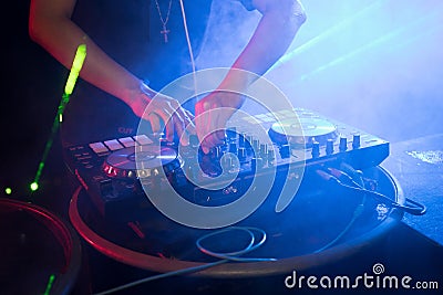 DJ playing turntable music on night club Stock Photo