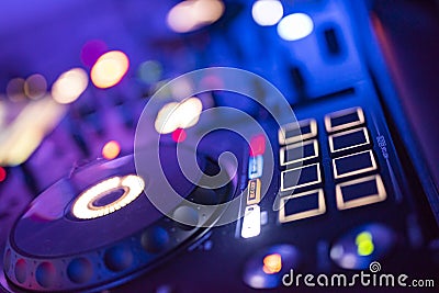 DJ Spinning, Mixing, and Scratching in a Night Club. DJ playing music at mixer . Closeup. Party. Stock Photo