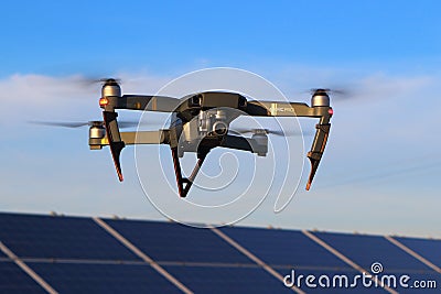 DJI Mavic Pro drone in flight above solar panels Editorial Stock Photo