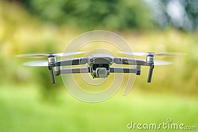 DJI Mavic 2 pro drone during flight against green defocused foliage Editorial Stock Photo