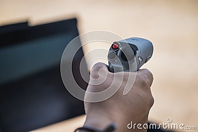 DJI Motion Control, used to steer DJI FPV drones, is held in hand with a blurred background Editorial Stock Photo