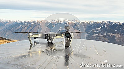 Dji Osmo pocket gimbal and Mavic Pro drone. Alps mountain range in the background Editorial Stock Photo