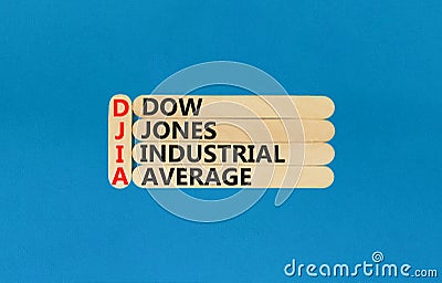 DJIA Dow Jones industrial average symbol. Concept words DJIA Dow Jones industrial average on wooden stick on beautiful blue Stock Photo