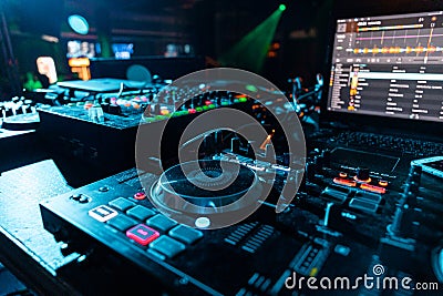 Djing console with laptop on a table in a club Stock Photo