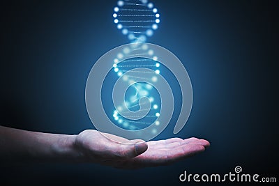 DNA and genetics research concept. Hand is holding glowing DNA molecule in hand Stock Photo