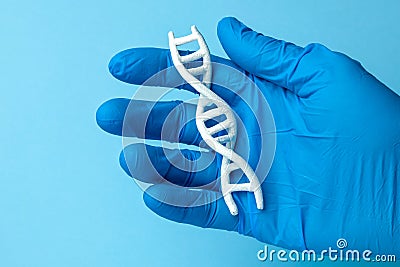 DNA helix research. Concept of genetic experiments on human biological code DNA. Scientist holds DNA helix. Stock Photo