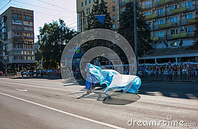 Citizens celebrate City Day. Rollerblading dancers waving the flag Editorial Stock Photo