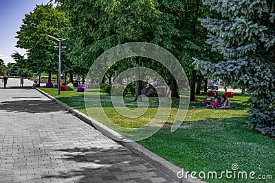 Lawn with families resting and bean bag chairs on Sicheslavskaya embankment in Dnipro. Relax Editorial Stock Photo