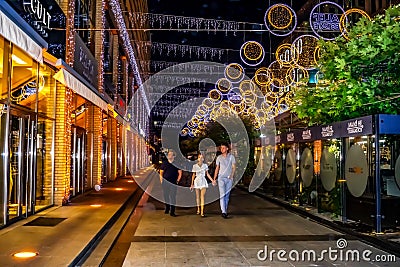 Tourists walk along the night Katerinoslavsky Boulevard in Dnipro. Beautiful city street Editorial Stock Photo