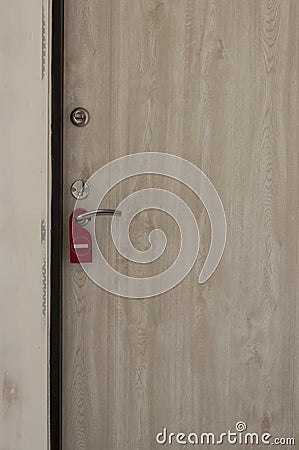 do not disturb door sign hanging at door handle Stock Photo