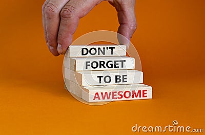 Do not forget awesome symbol. Concept words `Do not forget awesome` on wooden blocks on a beautiful orange background. Businessm Stock Photo