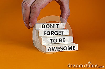 Do not forget awesome symbol. Concept words `Do not forget awesome` on wooden blocks on a beautiful orange background. Businessm Stock Photo