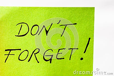 Do not forget handwriting text close up isolated on green paper with copy space. Writing text on memo post reminder Stock Photo