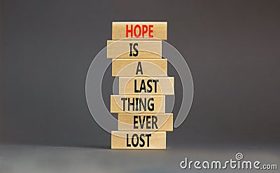 Do not lost hope symbol. Concept words Hope is a last thing ever lost on wooden blocks on a beautiful grey table grey background. Stock Photo