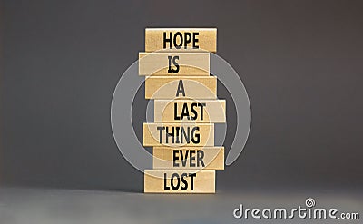 Do not lost hope symbol. Concept words Hope is a last thing ever lost on wooden blocks on a beautiful grey table grey background. Stock Photo