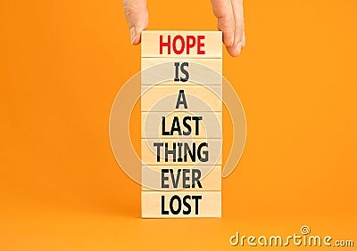 Do not lost hope symbol. Concept words Hope is a last thing ever lost on wooden blocks on a beautiful orange background. Stock Photo