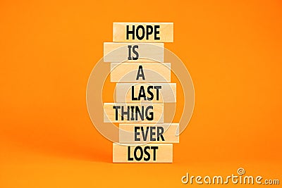 Do not lost hope symbol. Concept words Hope is a last thing ever lost on wooden blocks on a beautiful orange table orange Stock Photo