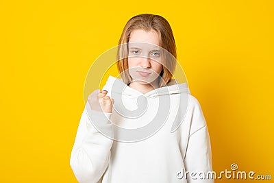 Do not mess with my anger. Annoyed girl clenches fist and looks irritated, dissatisfied with something, threatens to revenge Stock Photo