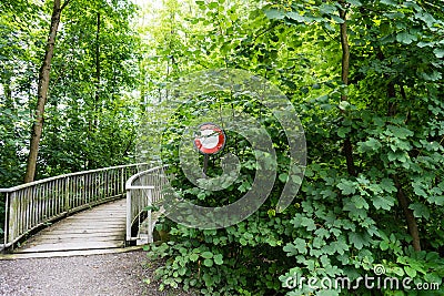 Do not pass stop sign in front of a bridge overgrown Stock Photo