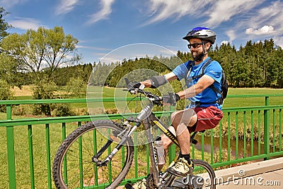 Young man trying a wheelie with his bike Editorial Stock Photo