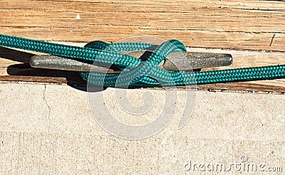 Dock cleat with a line securing a boat Stock Photo