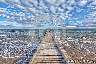 A dock leads to the mediterranean sea at the beach of Lido die Jesolo Stock Photo